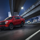 Red Tahoe prowling a night time freeway.